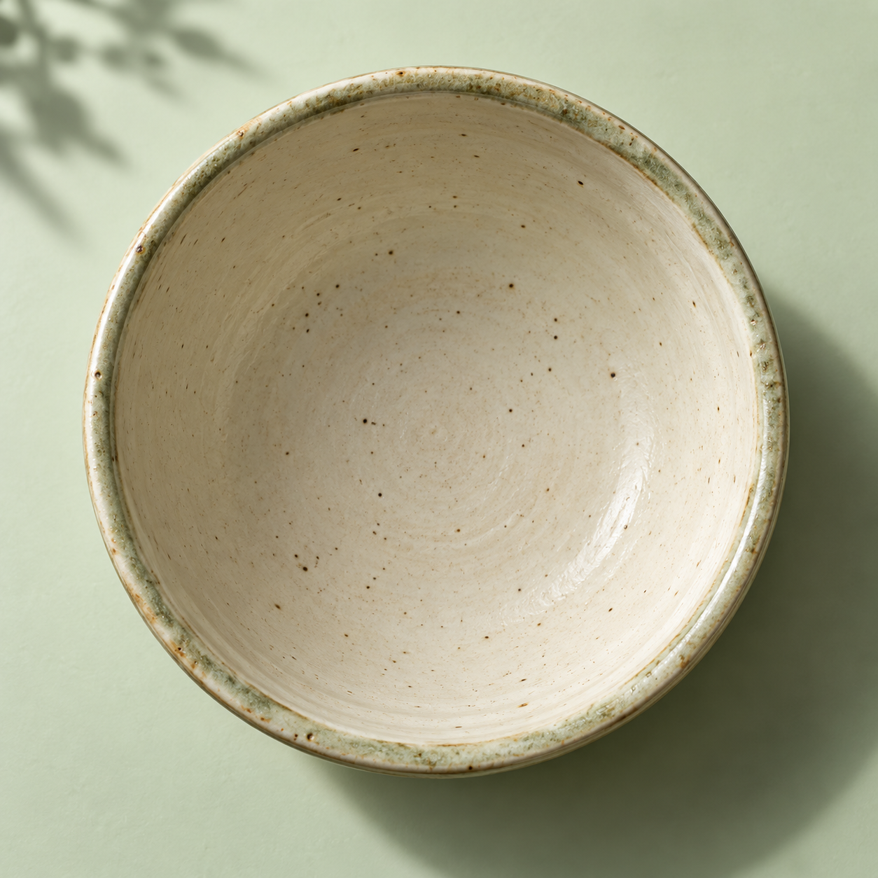 An overhead view of a handmade ceramic matcha bowl. The interactive illustration changes from powder to water to foamy matcha as you prepare each step.
